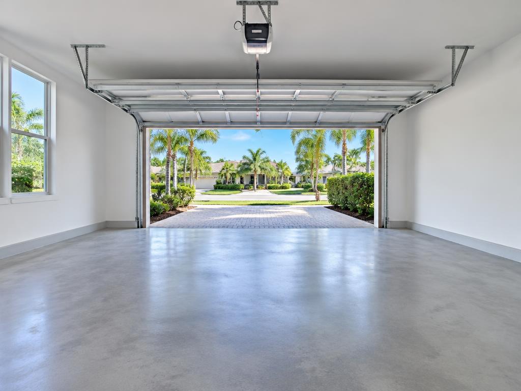 Cleared garage with an open door and clean concrete floor